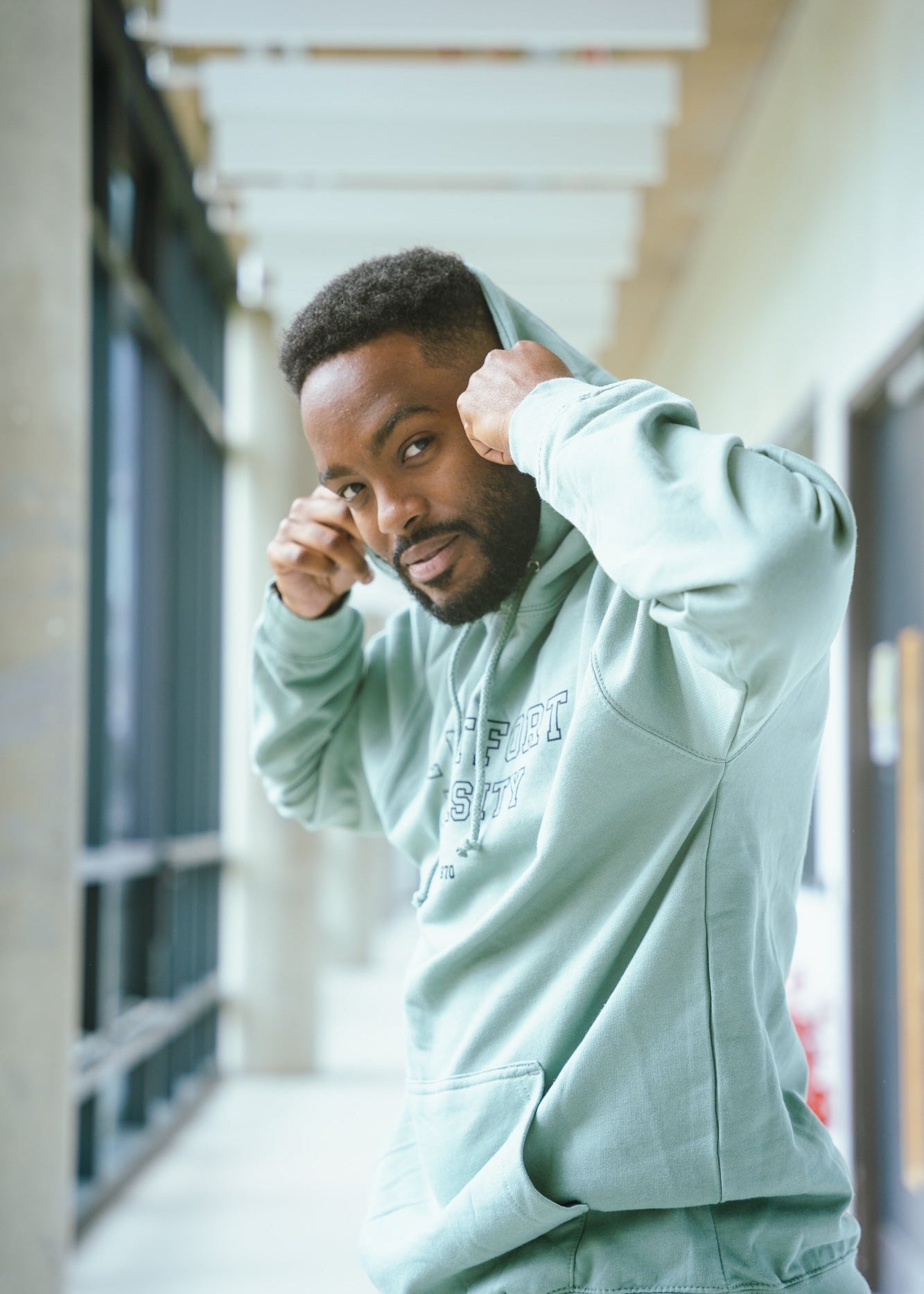 Student wearing DMU Campus Essentials Branded Hoodie